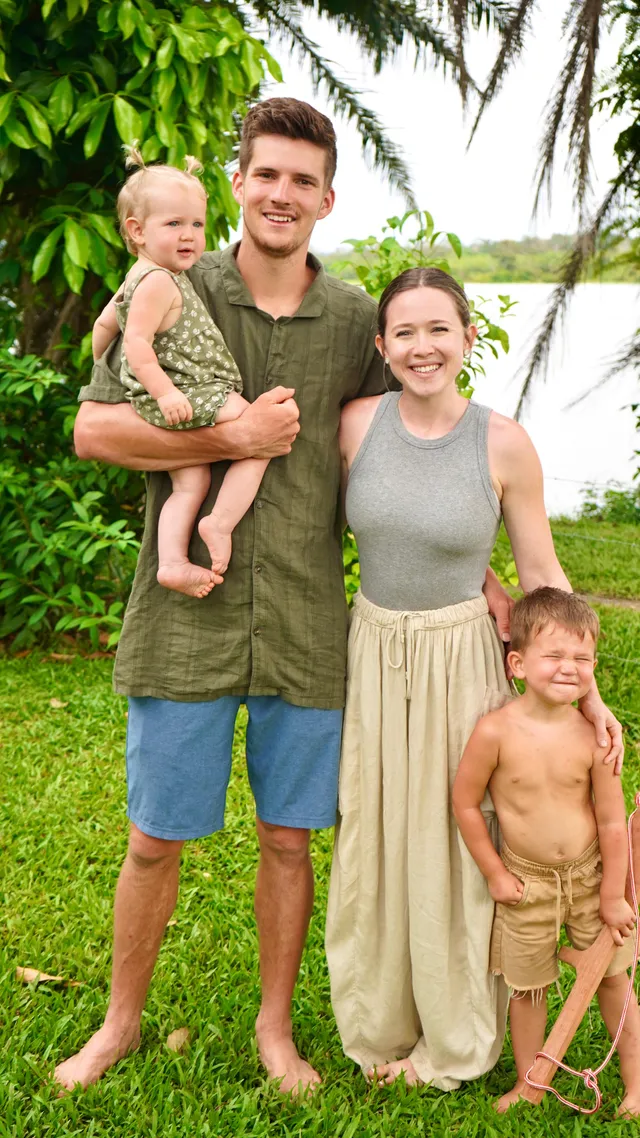 The Draxlir family outdoors among palm trees